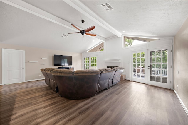 living room featuring a textured ceiling, dark wood-type flooring, french doors, and lofted ceiling with beams