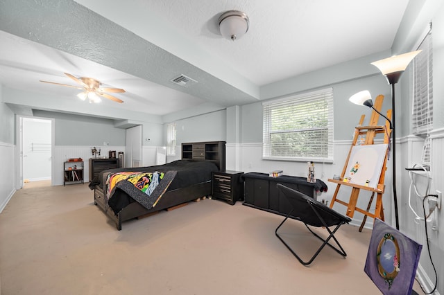 bedroom with a textured ceiling and ceiling fan