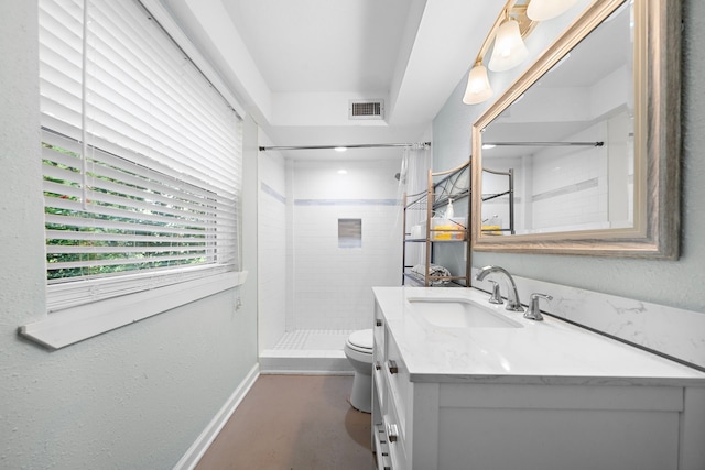 bathroom featuring vanity, toilet, and walk in shower