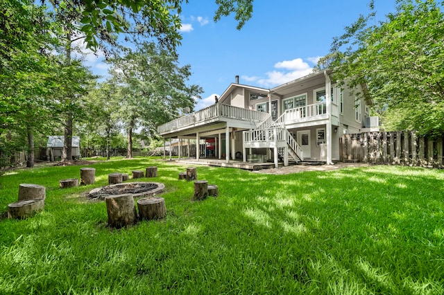 back of house with a deck and a yard