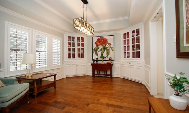 sitting room with ornamental molding and dark hardwood / wood-style floors