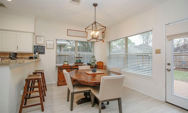 tiled dining room with a wealth of natural light, a chandelier, and ornamental molding