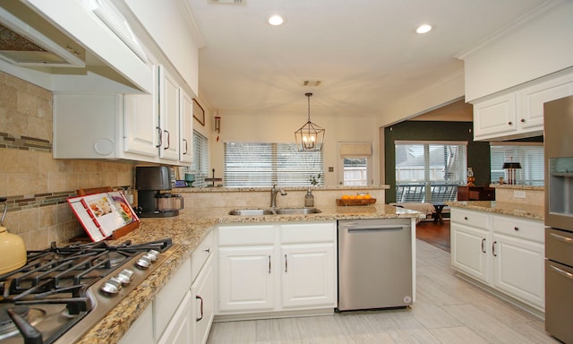 kitchen with decorative light fixtures, a notable chandelier, sink, stainless steel appliances, and white cabinets