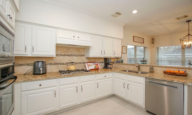 kitchen with white cabinets, appliances with stainless steel finishes, and sink