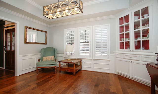 living area featuring ornamental molding and dark hardwood / wood-style floors