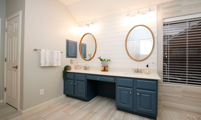 bathroom featuring lofted ceiling and vanity