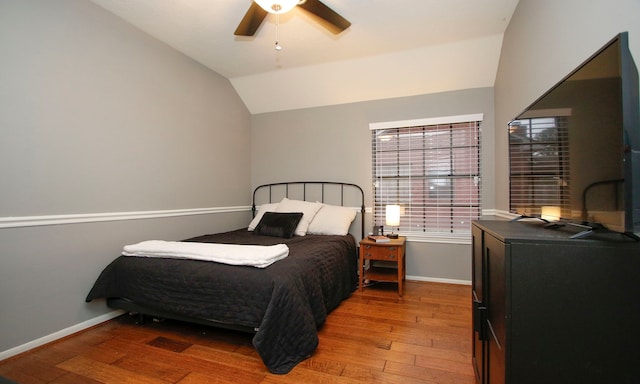 bedroom featuring ceiling fan, wood-type flooring, and lofted ceiling