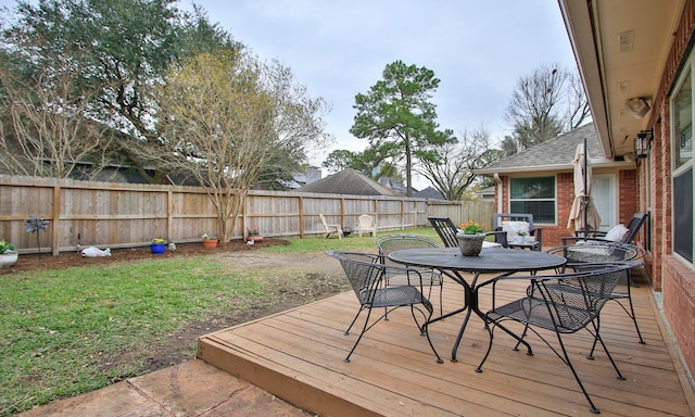 wooden terrace featuring a yard