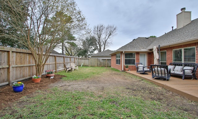 view of yard with a wooden deck and an outdoor living space