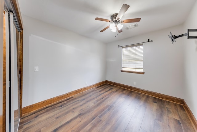 unfurnished room featuring ceiling fan and dark hardwood / wood-style floors