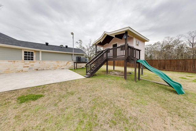 view of playground featuring a patio area and a yard