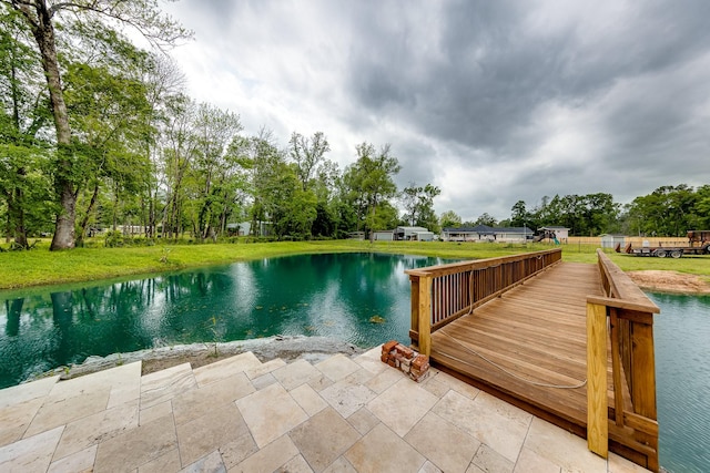 dock area featuring a water view and a lawn