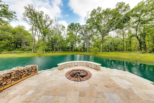 view of patio / terrace featuring a water view and an outdoor fire pit