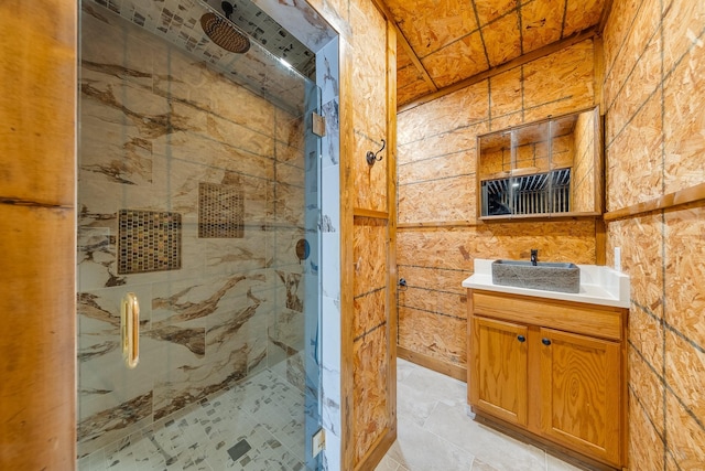 bathroom with vanity and a shower with door