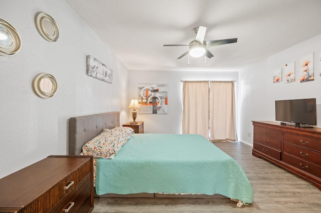 bedroom with ceiling fan and light wood-type flooring