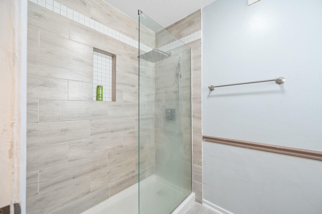 bathroom with tiled shower