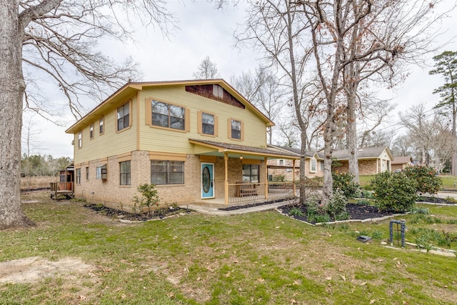 rear view of property with a lawn and a porch