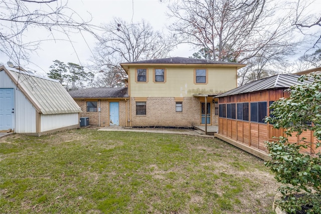 back of property with a shed, cooling unit, and a yard