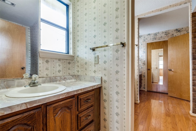 bathroom with vanity and hardwood / wood-style floors