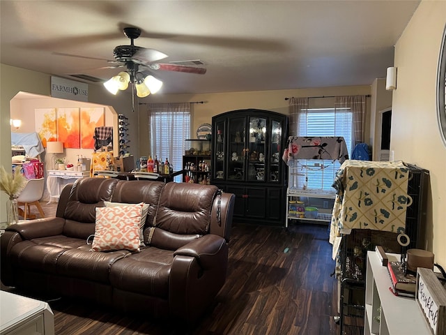 living room with ceiling fan and dark hardwood / wood-style flooring