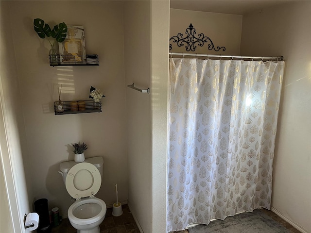 bathroom with toilet and walk in shower