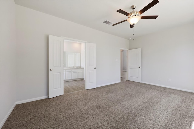 unfurnished bedroom with ceiling fan and light colored carpet