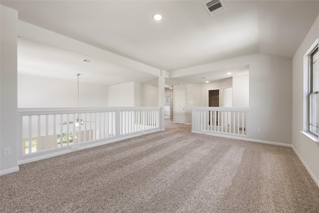 carpeted empty room with lofted ceiling