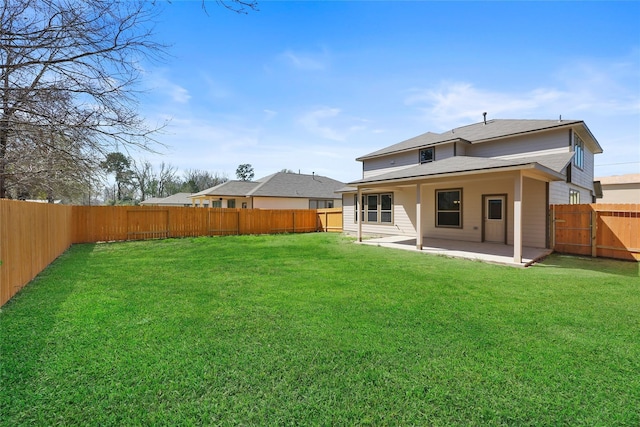 back of property with a lawn and a patio area