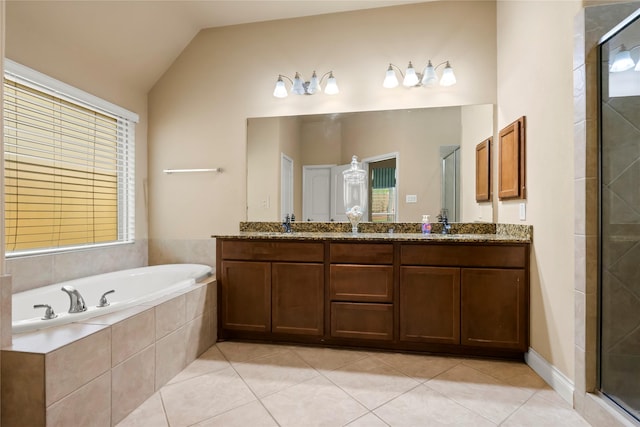 bathroom with separate shower and tub, vanity, vaulted ceiling, and tile patterned floors