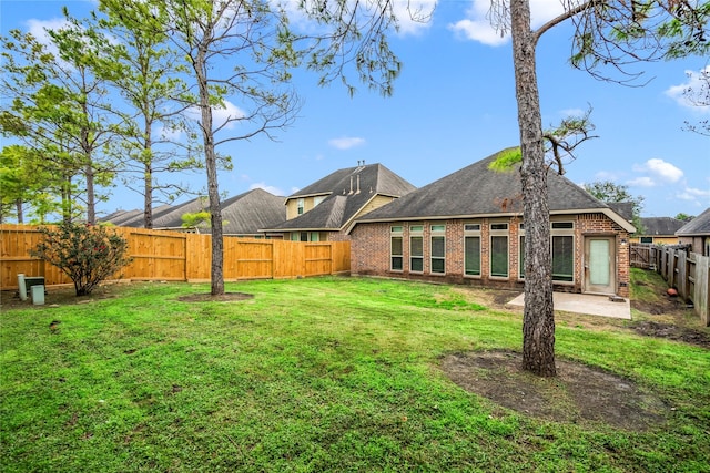 rear view of house with a yard and a patio