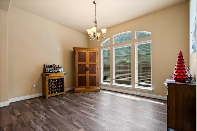 unfurnished dining area with dark wood-type flooring and a notable chandelier