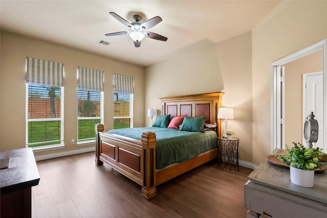 bedroom with ceiling fan and dark hardwood / wood-style floors