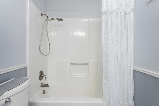 bathroom with toilet and shower / tub combo with curtain