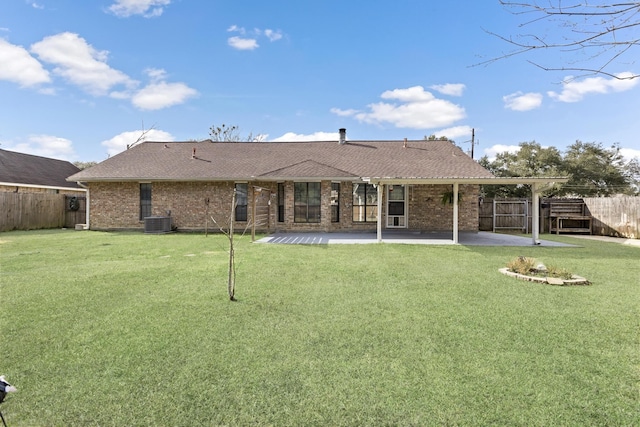 back of property featuring cooling unit, a patio area, and a yard