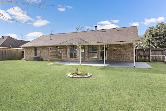 back of house featuring a patio area, cooling unit, and a yard