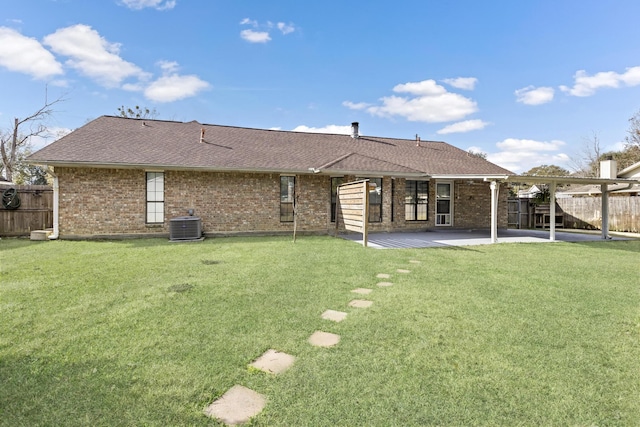 rear view of property with a lawn and a patio