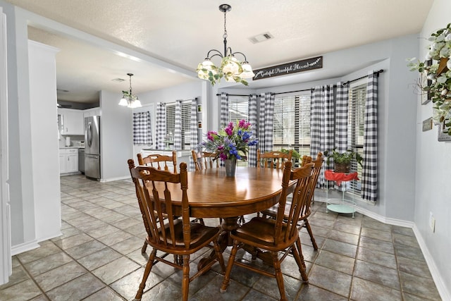 dining area with an inviting chandelier and a wealth of natural light