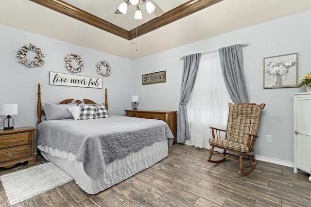 bedroom featuring ceiling fan, a tray ceiling, and crown molding