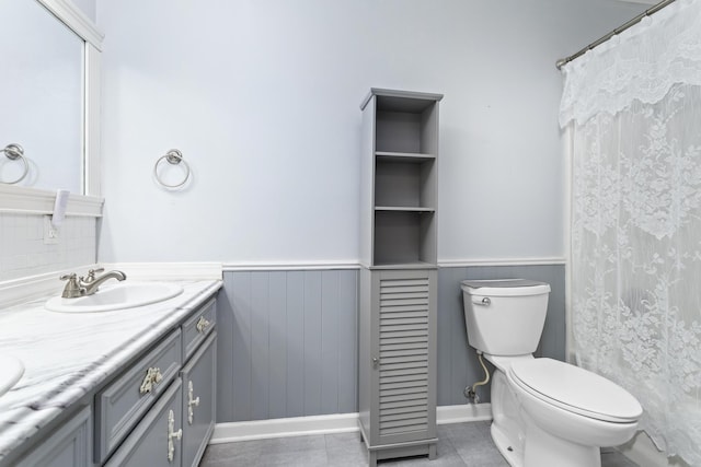 bathroom featuring tile patterned floors, toilet, and vanity