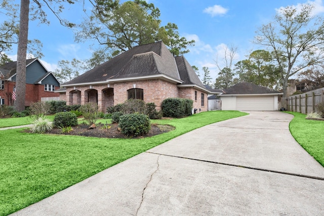 view of side of property with a garage and a lawn