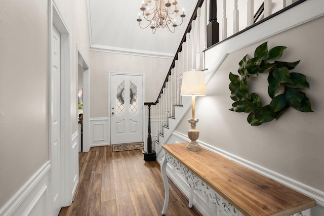 foyer with hardwood / wood-style flooring and a notable chandelier