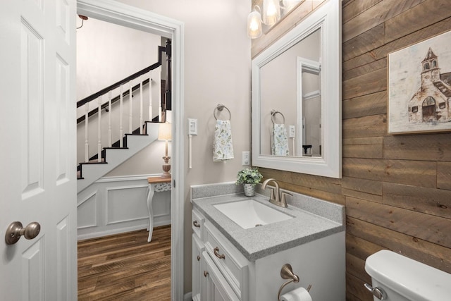 bathroom with wood-type flooring, toilet, and vanity