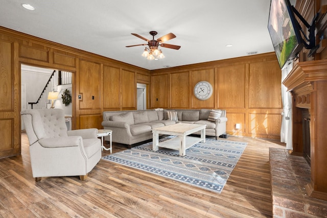 living room featuring hardwood / wood-style flooring and ceiling fan