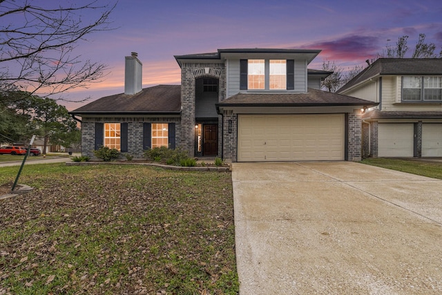 view of front of house featuring a yard and a garage