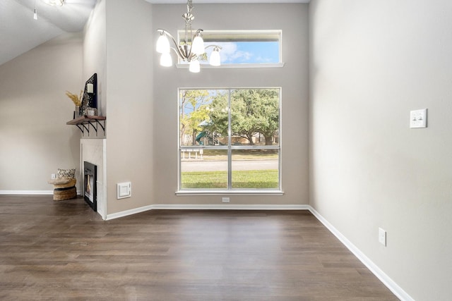 unfurnished dining area with dark hardwood / wood-style floors and a chandelier