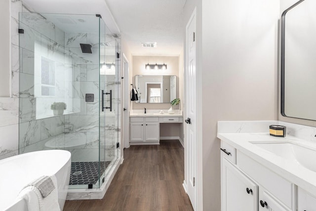 bathroom featuring separate shower and tub, wood-type flooring, and vanity