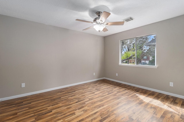 empty room with ceiling fan and hardwood / wood-style flooring