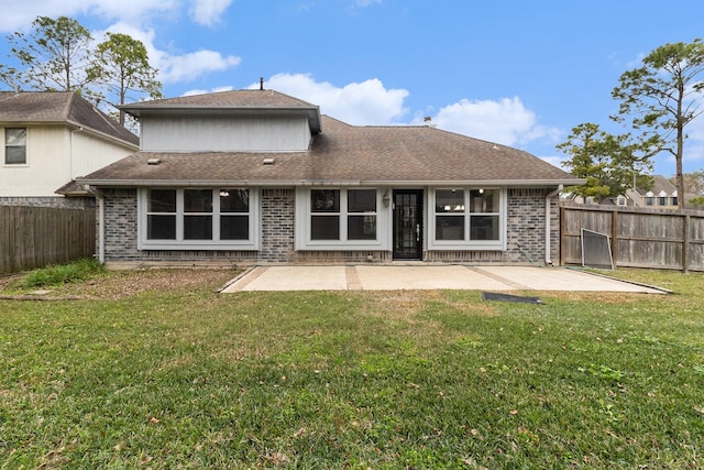 back of house featuring a lawn and a patio