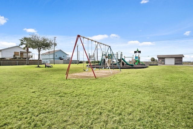 community jungle gym with a lawn and fence