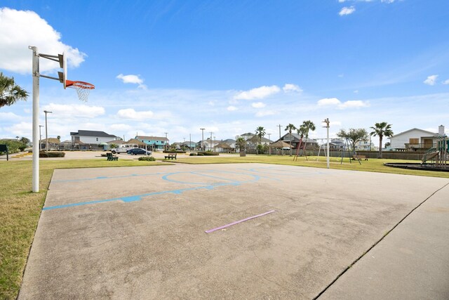 view of sport court featuring a lawn and a playground